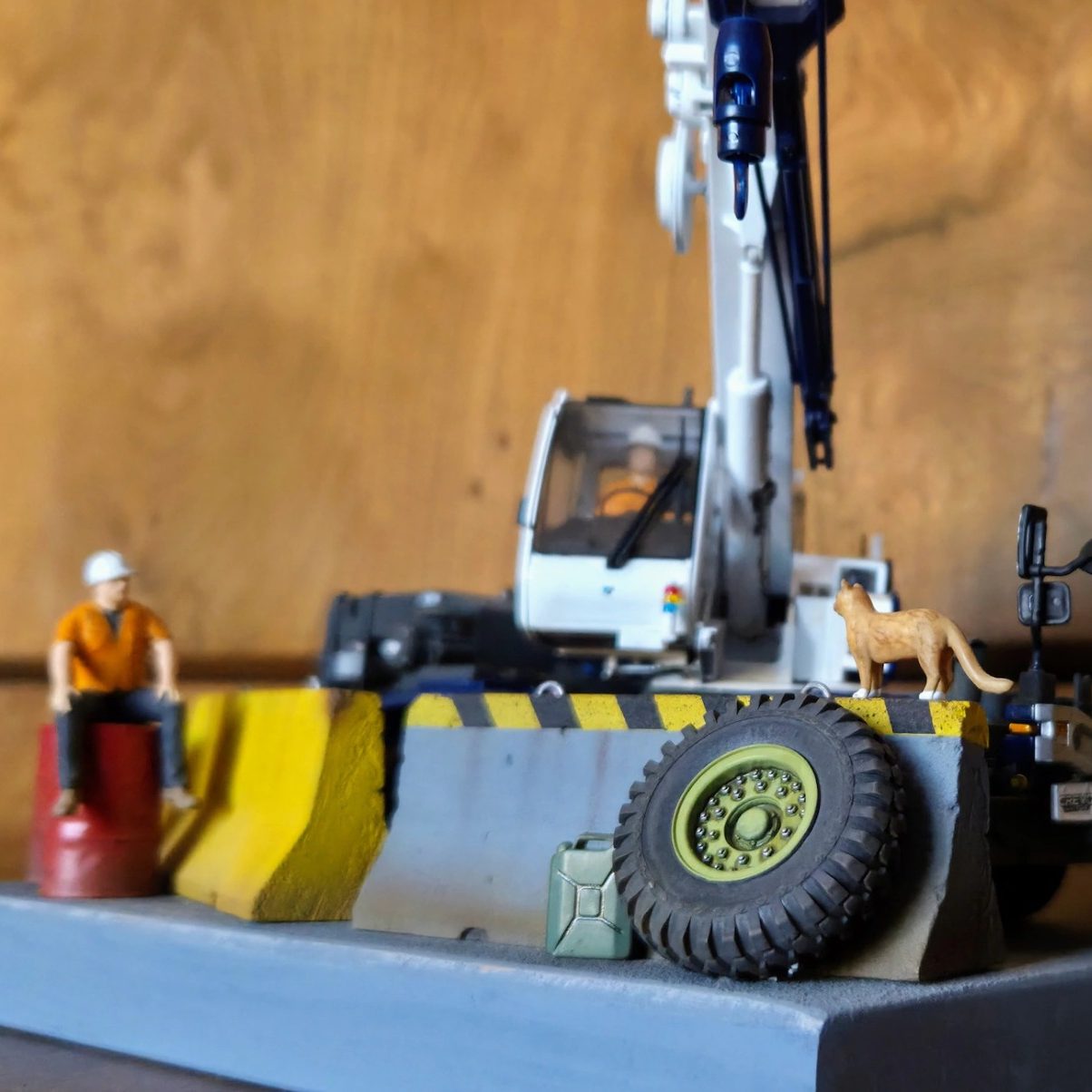 A model crane truck with a blue and white design on a grey base.