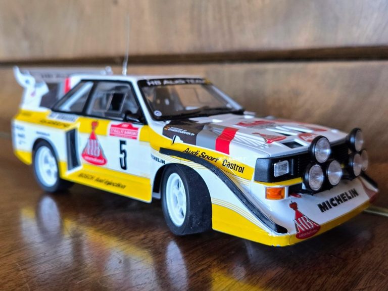 A detailed model of a rally car featuring multiple front lights and Michelin branding. A detailed model of a rally car featuring multiple front lights and Michelin branding.