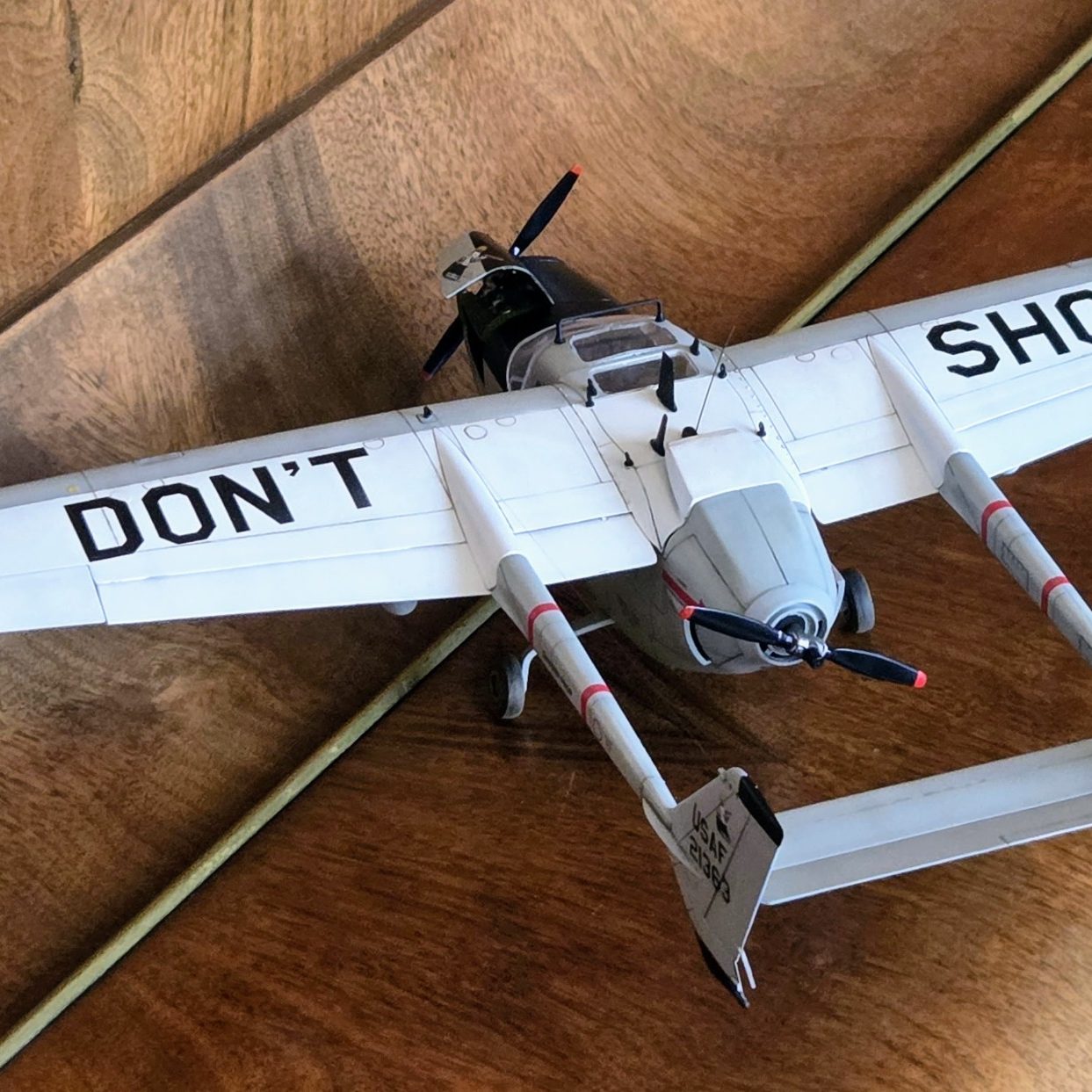 Model car of a rally vehicle, featuring a distinctive white and yellow livery with sponsor logos.